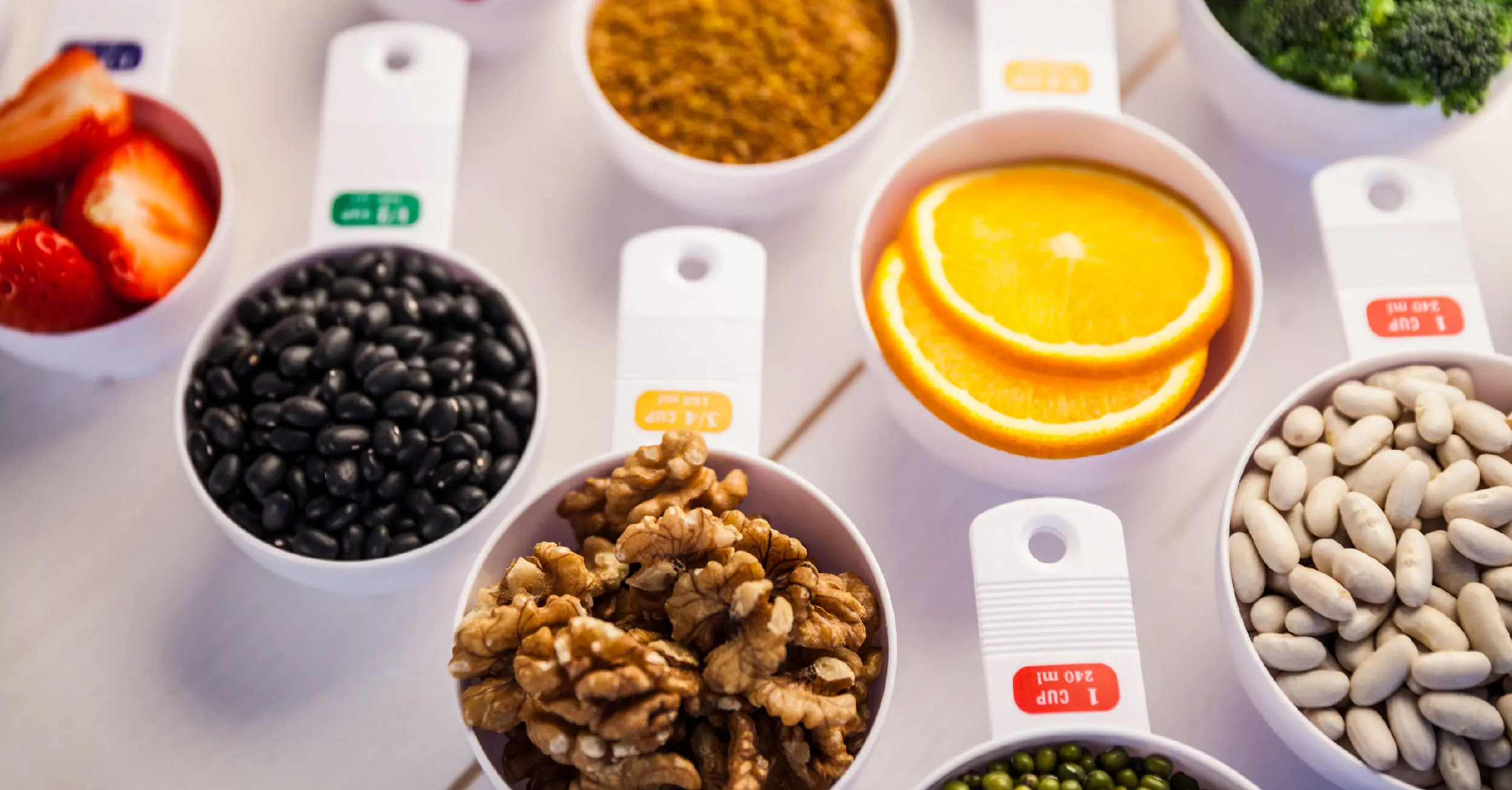 portion cups of healthy ingredients on wooden table